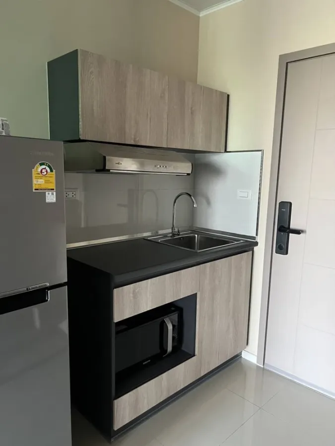 For sale/rent: D Condo Hideaway Rangsit Phase 4. There is a glass door separating the bedroom and kitchen. Very attractive.