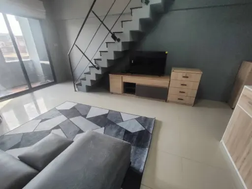 Condo for rent, Champs Elysees Tiwanon, duplex room, nice sofa to sit on, plus lots of usable space. Book now.