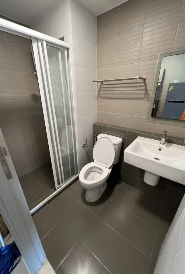 For sale/rent: D Condo Hideaway Rangsit Phase 4. There is a glass door separating the bedroom and kitchen. Very attractive.