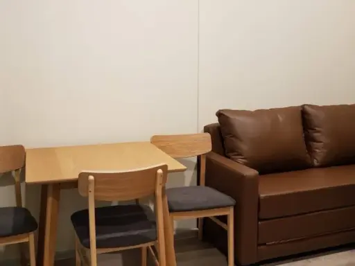 Knightsbridge Collage Ramkhamhaeng for rent, a cozy room with complete electrical appliances and a comfortable brown sofa. Don't miss it! images