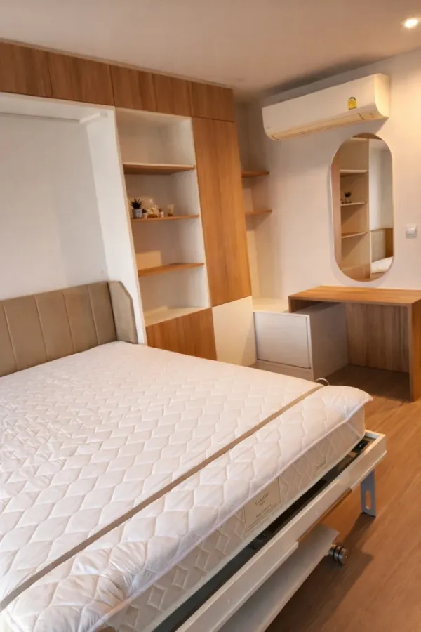For rent: Life Ladprao condo with multi-functional furniture. The well-designed furniture maximizes space, making the room feel spacious, airy, and in