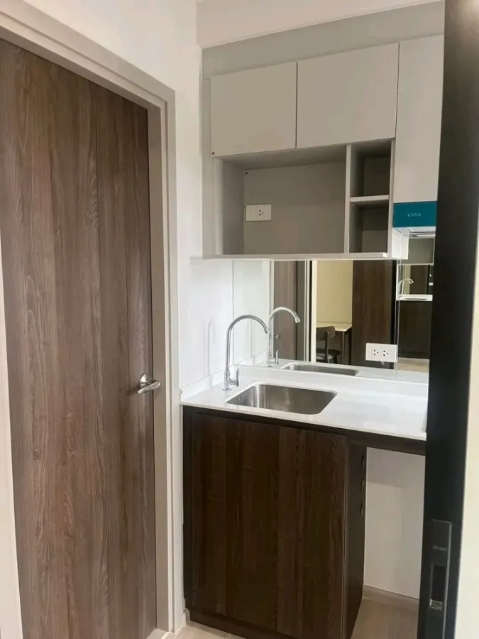 Condo down payment for sale, New Cross Khu Khot Station, studio room, 7th floor, BTS view, building next to the road, buy now.
